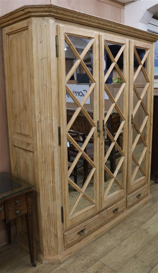 A distressed pine mirrored three door wardrobe W.188cm H.202cm